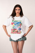 Woman wearing a white t-shirt with colorful graphic design and text saying Marriage Material.