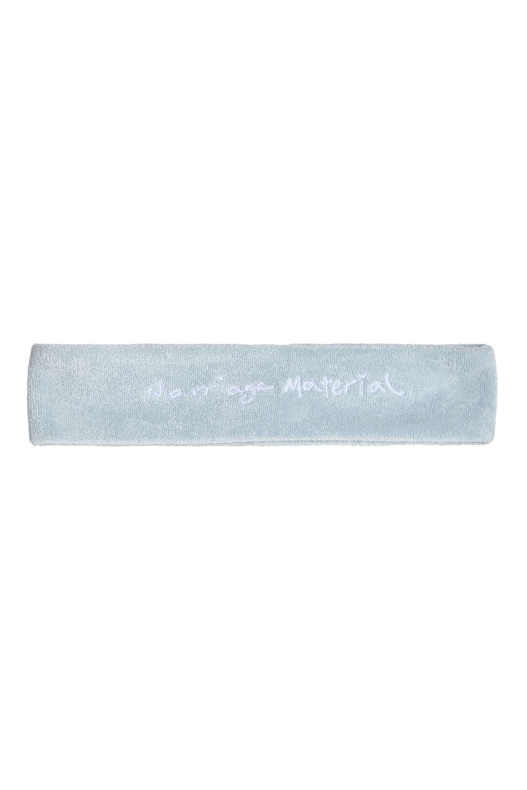 Flat lay of white terry cloth headband with 'Marriage Material™' embroidery