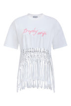 White t-shirt with fringe details and pink text on a white background