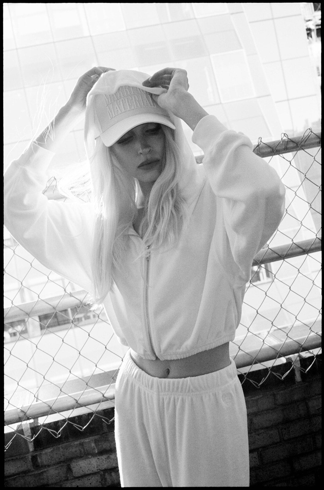 White terry bridal hoodie on model, hood up and fully zipped, showing relaxed fit